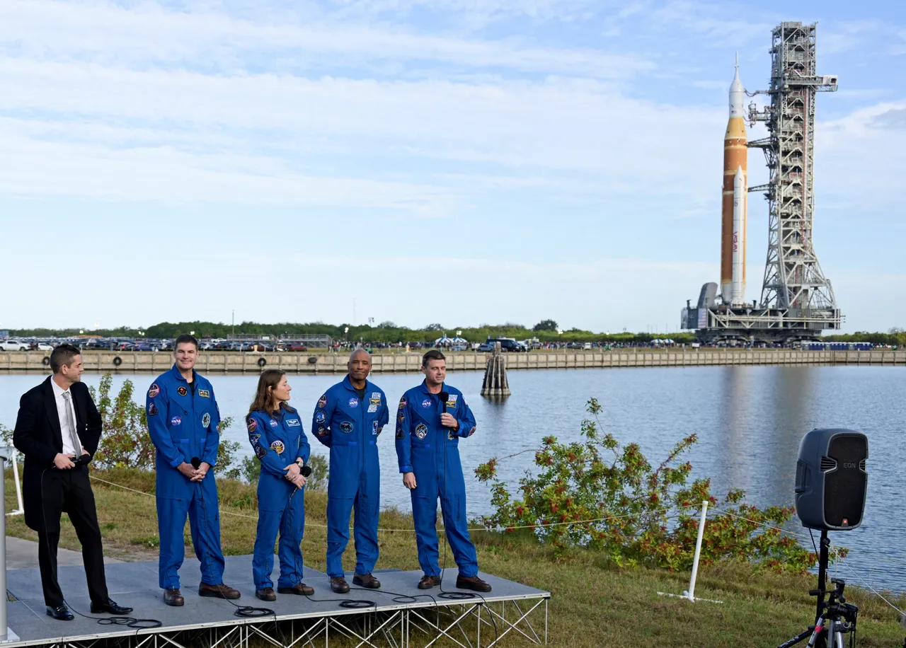 The Space Launch System rocket with the Orion crew capsule, rolls out of the Vehicle Assembly Building towards launch complex 39B