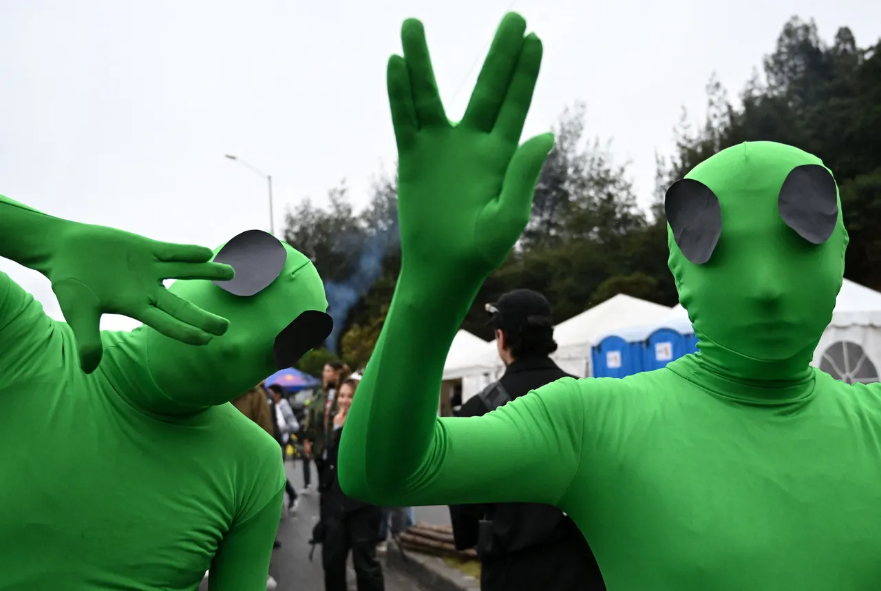 Participants dressed as aliens wait their turn to compete in their homemade carts during the  "Balineras" race in Bogota on September 29, 2024.